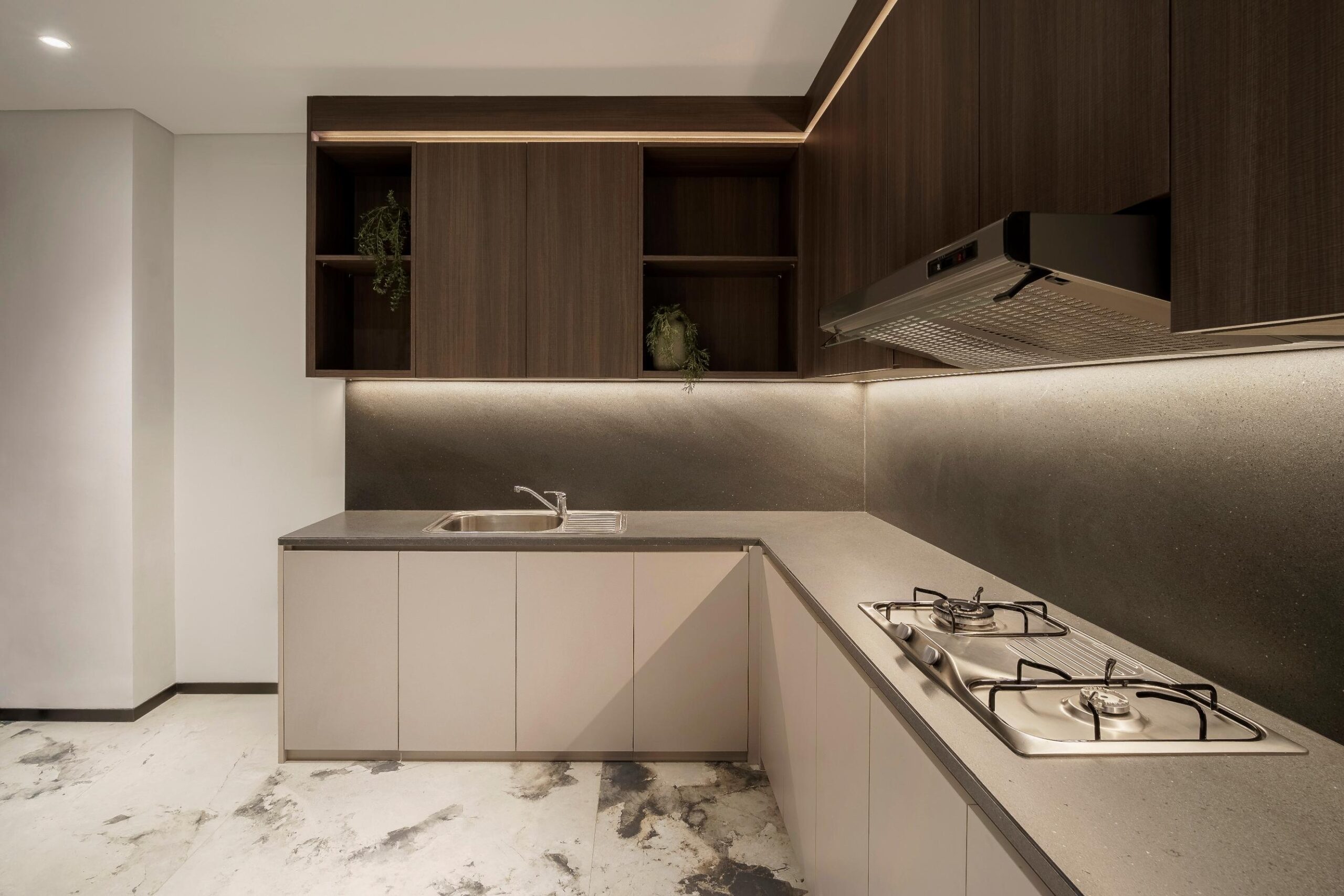 L-shaped modular kitchen design with dark wood cabinets and granite countertop