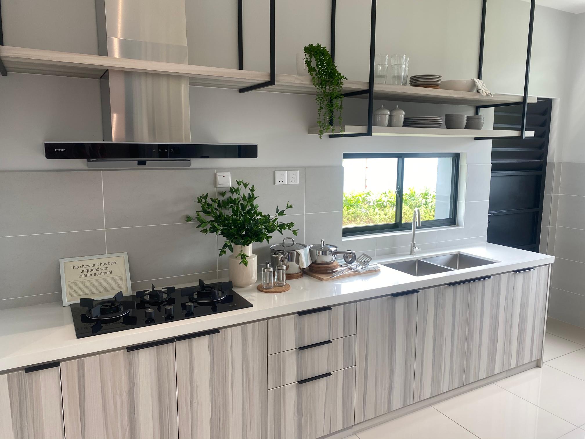 Modern low-budget modular kitchen with light wood laminate finish and island counter